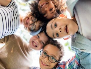 Diverse children engaged in individualized learning activities at Tiny Tots Christian Academy